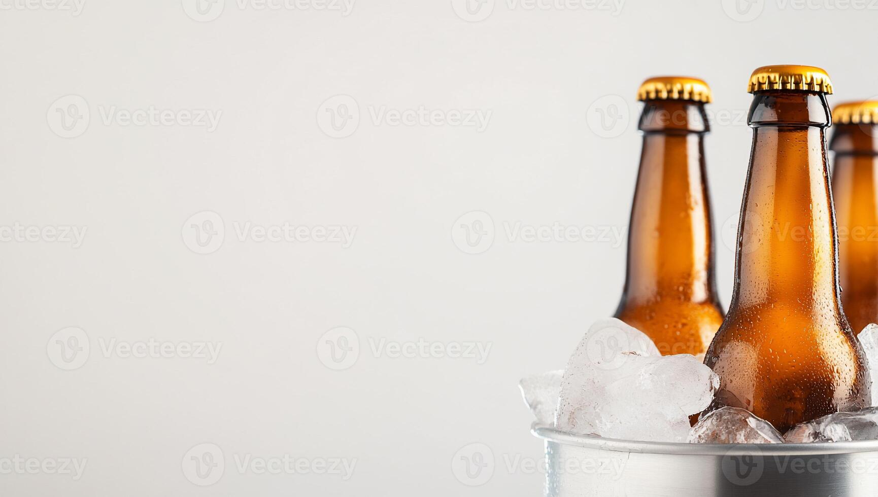 Three beer bottles in a bucket with ice photo