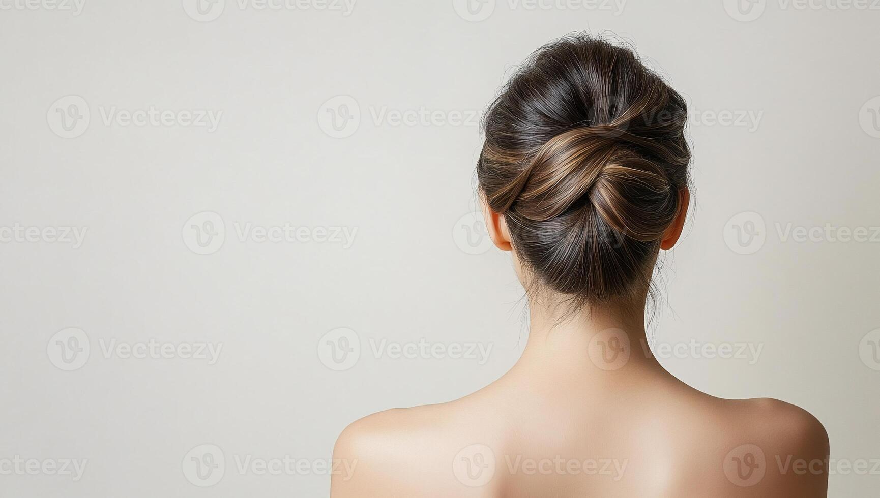 A woman with a messy bun in her hair photo
