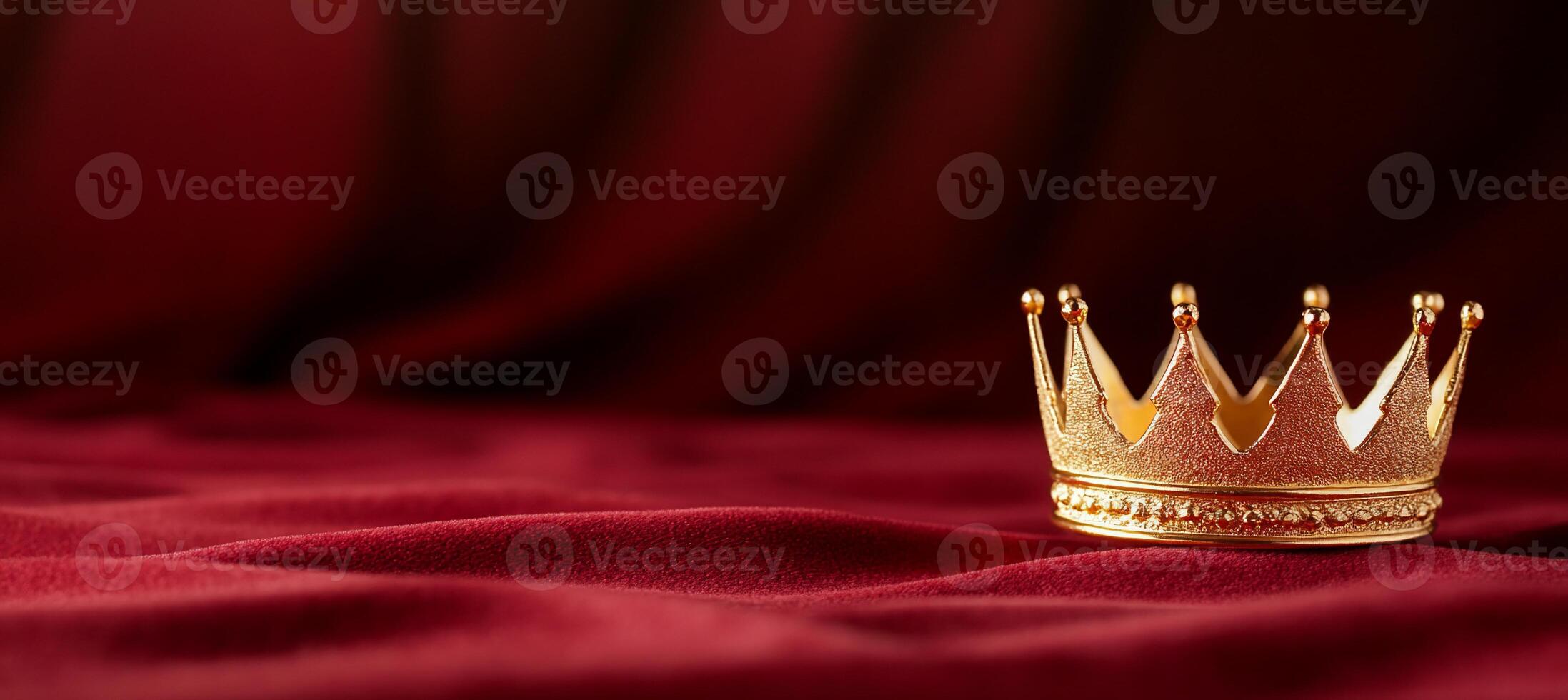 A golden crown rests on rich red fabric, symbolizing royalty and power. photo