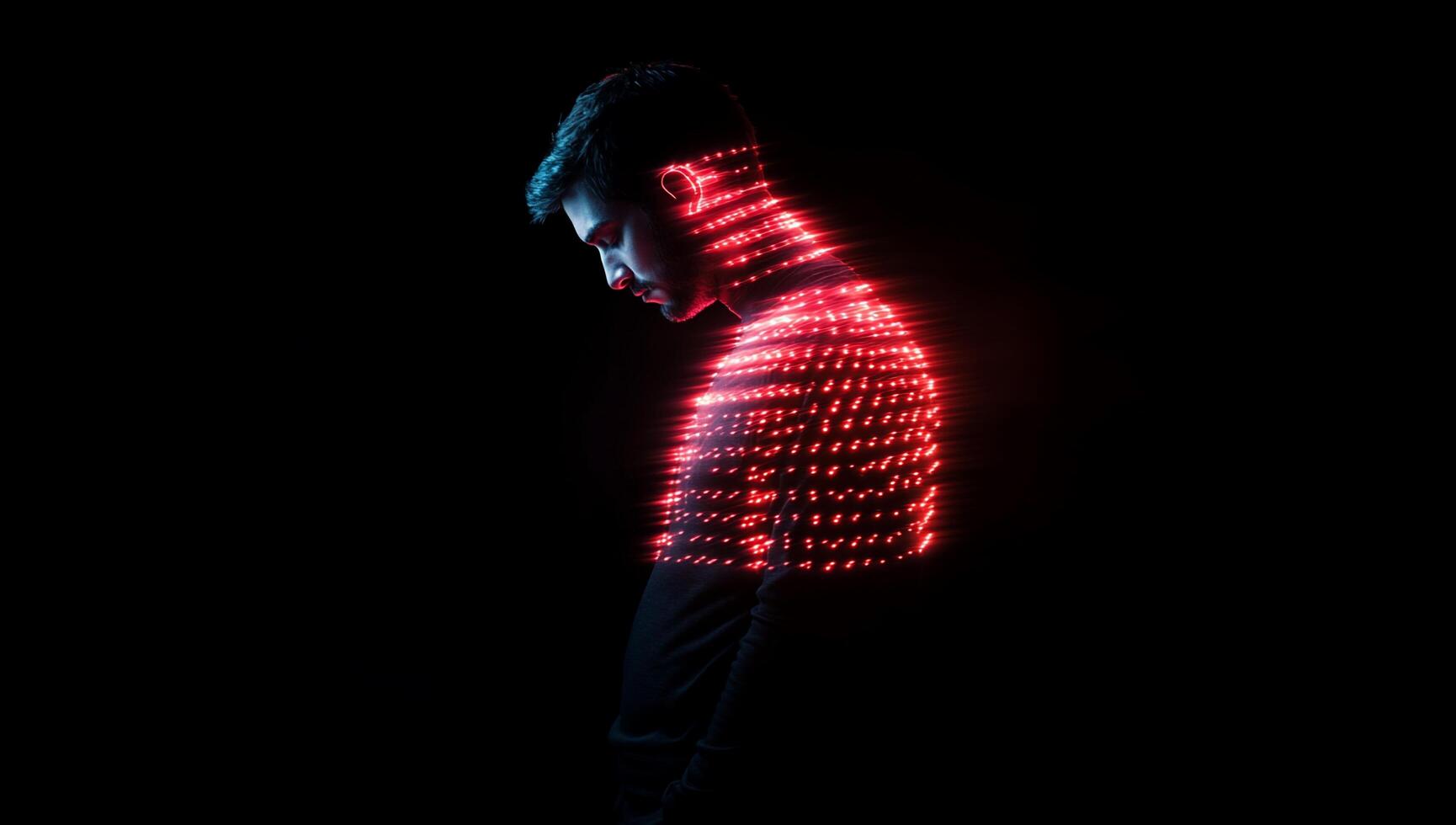A silhouette of a man with a glowing digital pattern overlay. photo