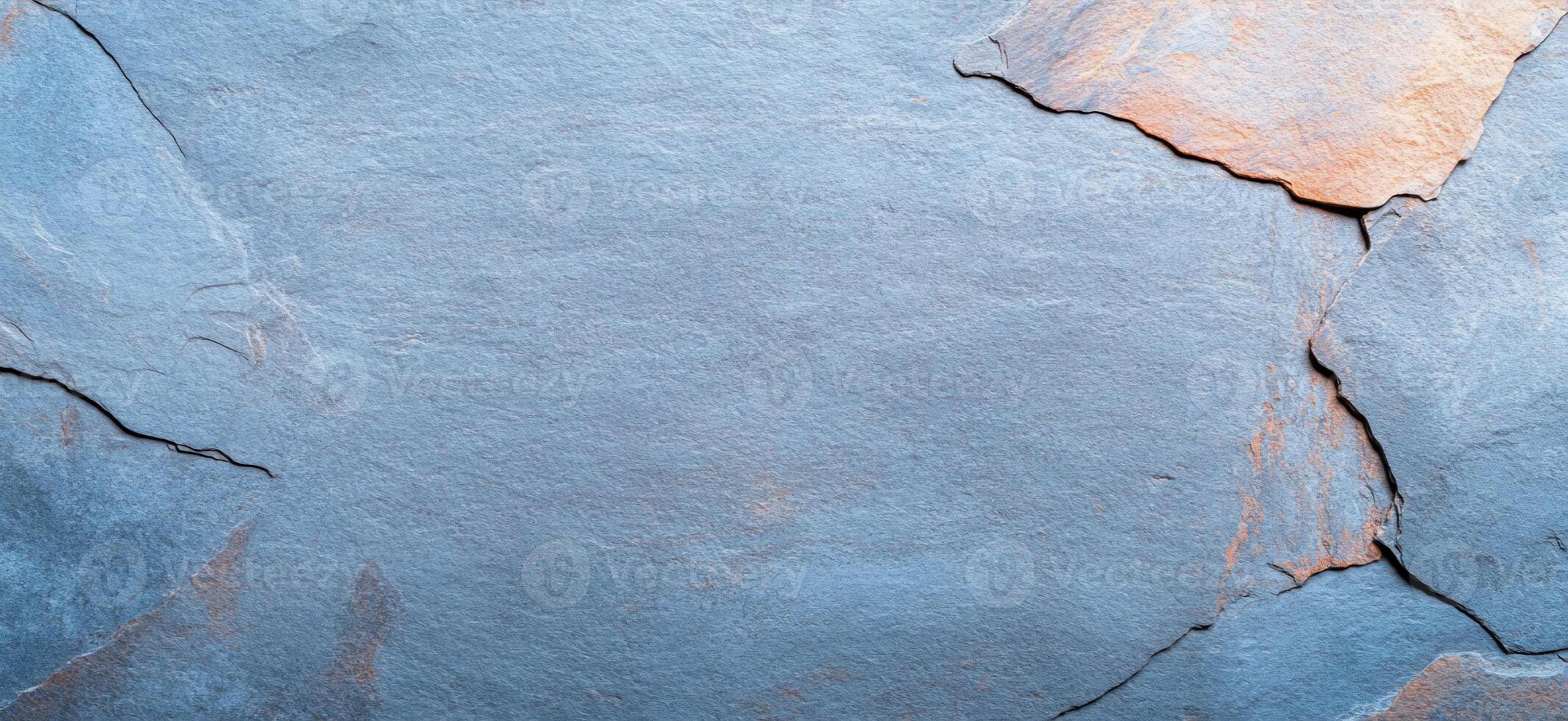 A textured slate stone surface with natural variations in color. photo