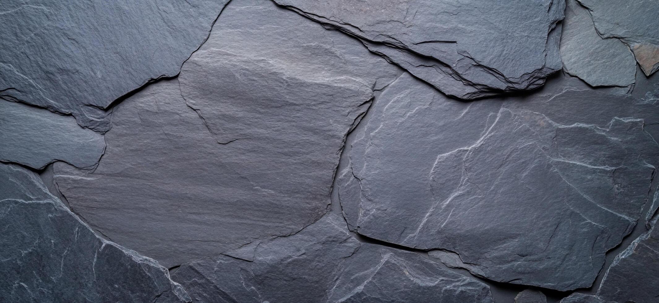 A close-up view of textured slate stone surface. photo