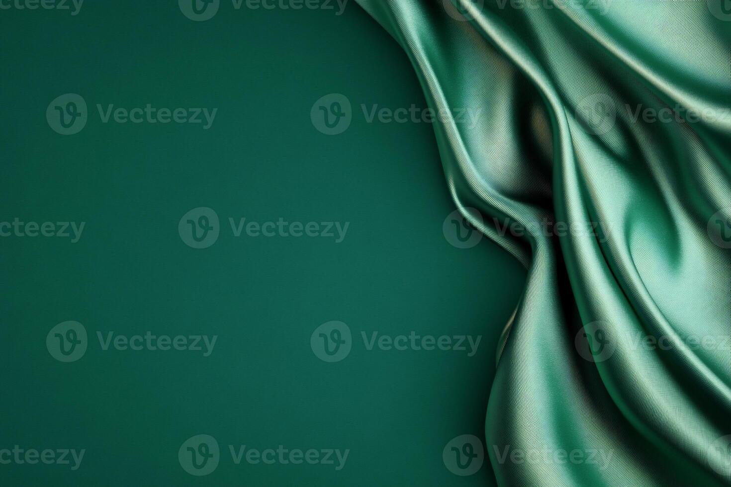 Green silk fabric with folds on a dark background photo