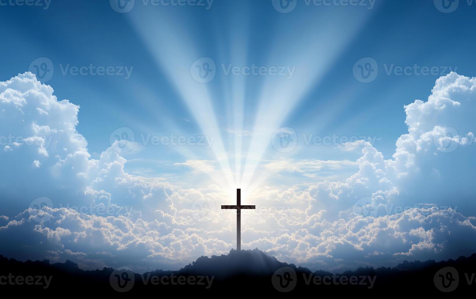 A silhouette of a cross against a radiant sky and clouds. photo