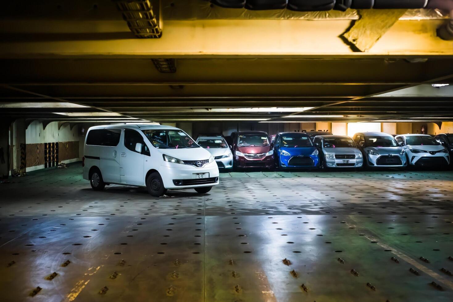 Vladivostok, Russia - 3 March 2024 unloading of new car from the ship inside in sea port of Vladivostok, Russia, inside of ship photo