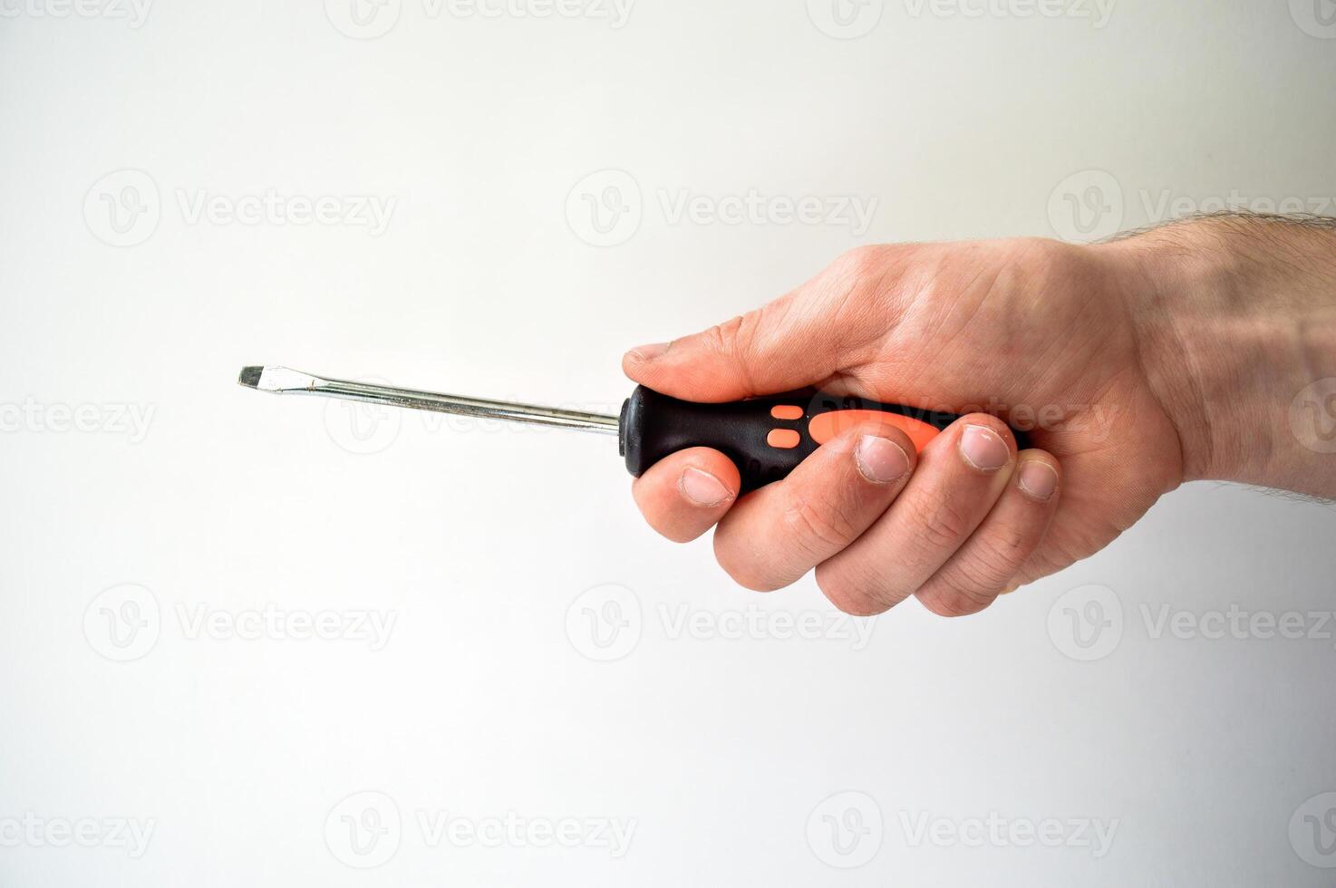 Male's hand holding screwdriver isolated on white background photo