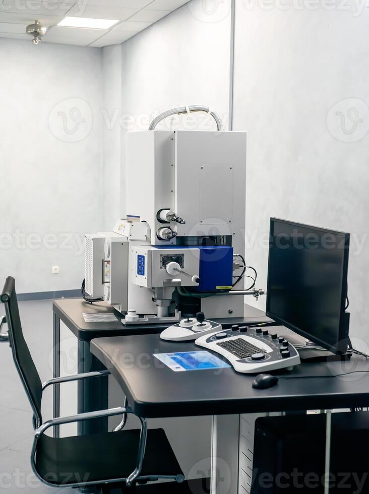 Work space of a scientist with Electron microscope, table and computer photo