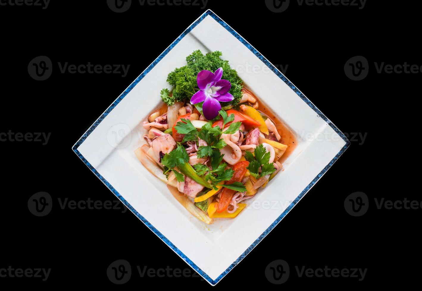 Vietnamese calamari with stewed vegetables and pineapple isolated on black background photo