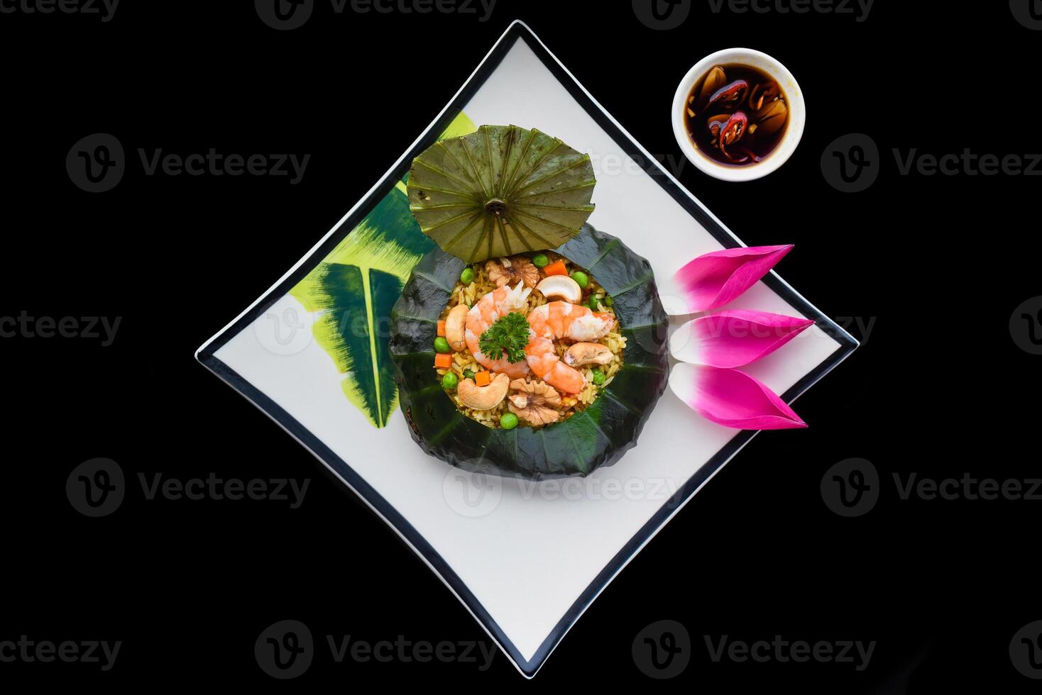 Vietnamese fried rice with vegetables, nuts and shrimps in lotus leaf isolated for a menu photo