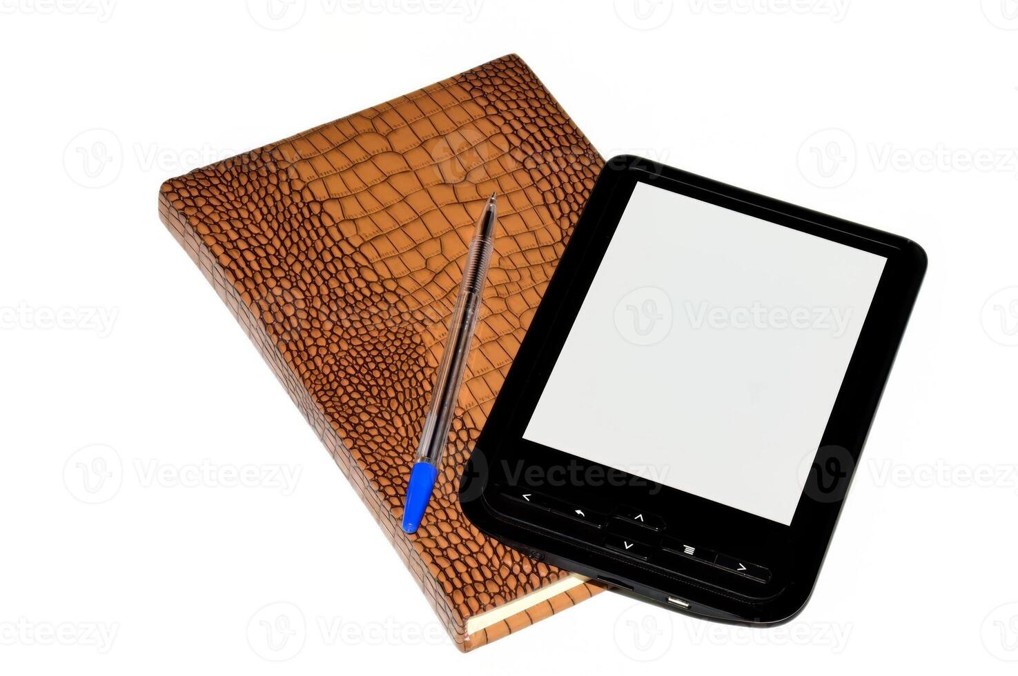 E-book on top of closed notebook with a blue pen isolated on white background photo