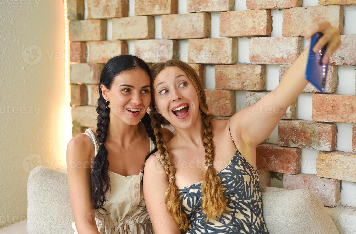women portrait together with braids posing and taking a selfie photo