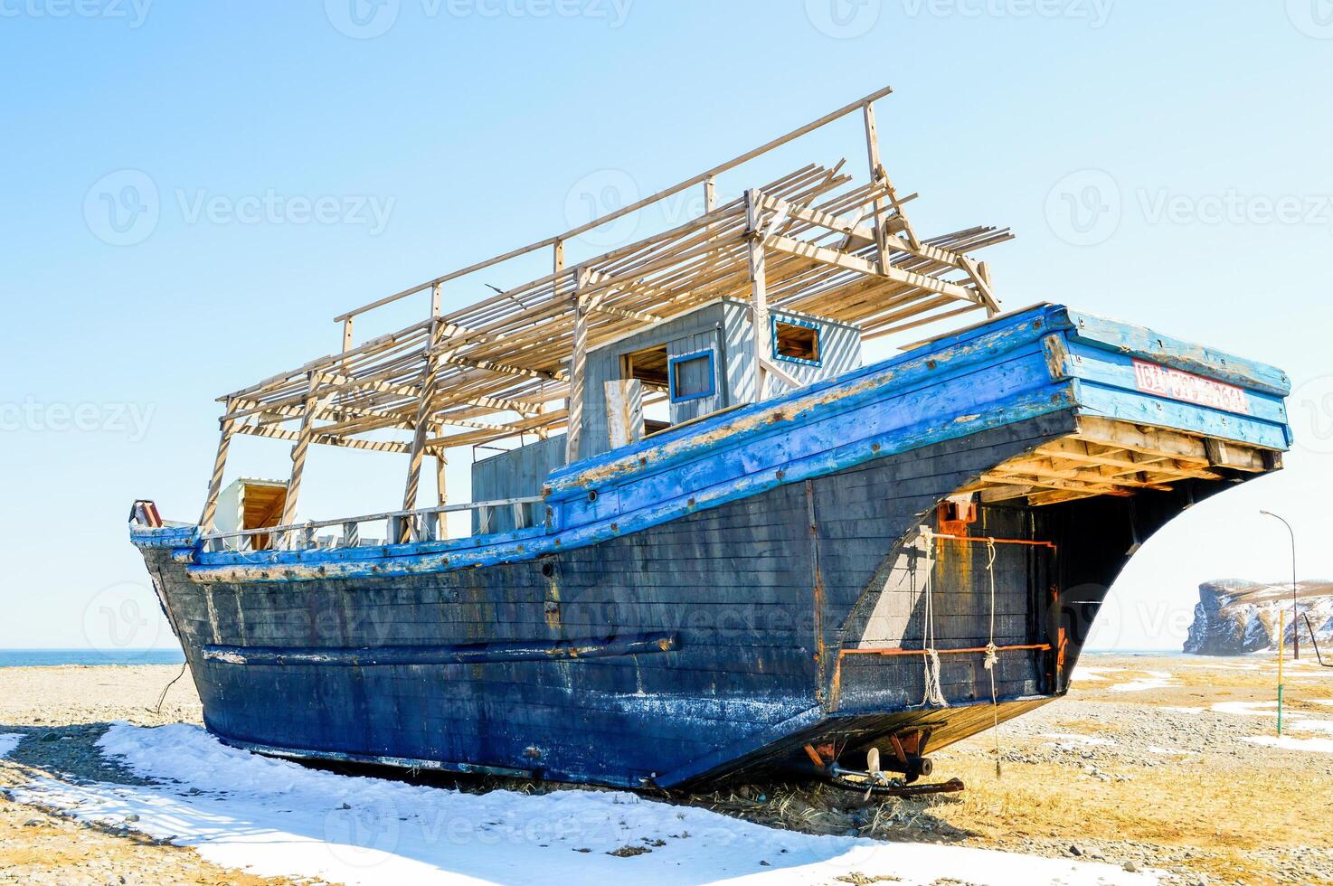 Abandoned North Korean fishing schooner on the shore of the japanese sea, Primorye, Russia. photo