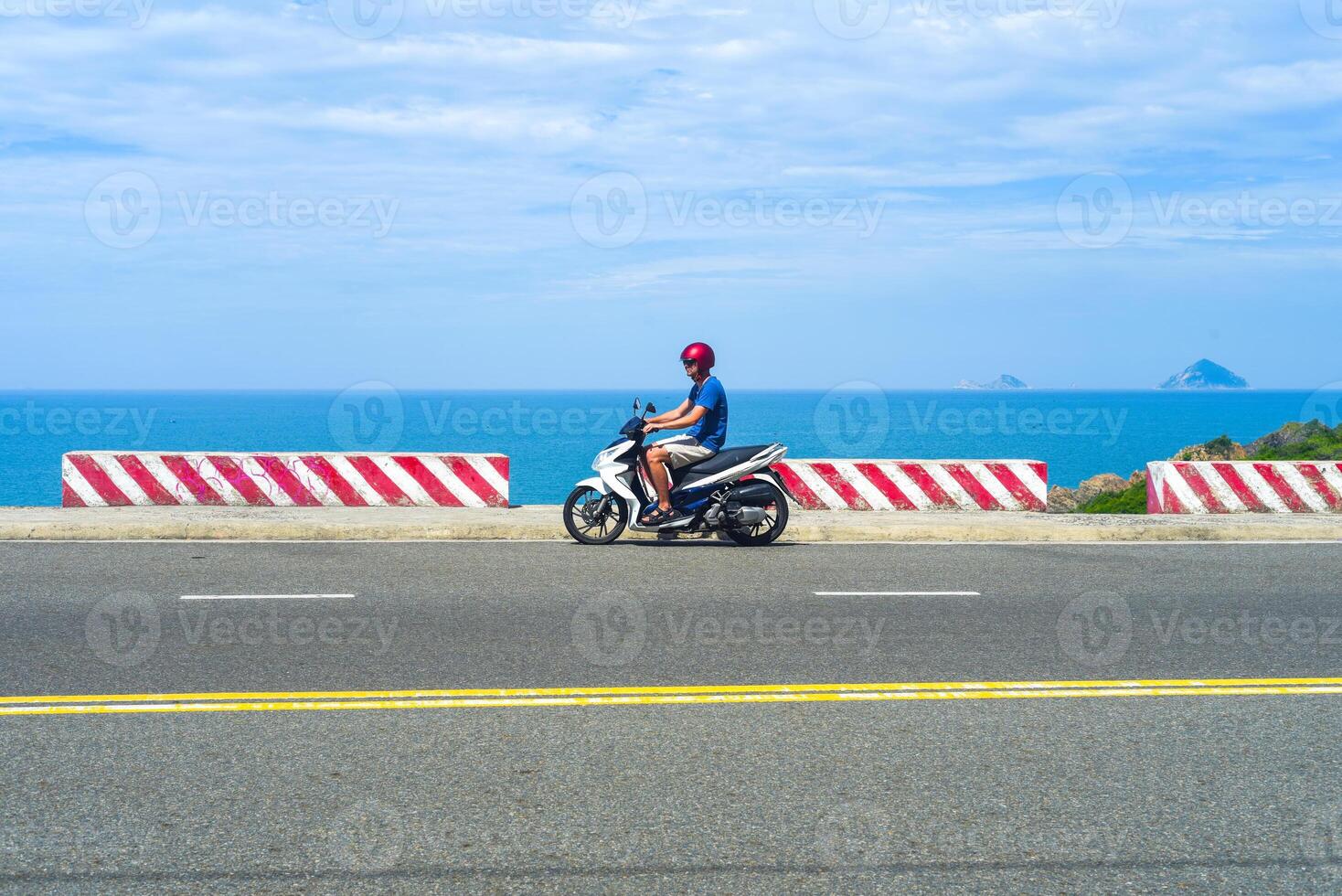 Young man a motorbike driver driving in vietnam photo