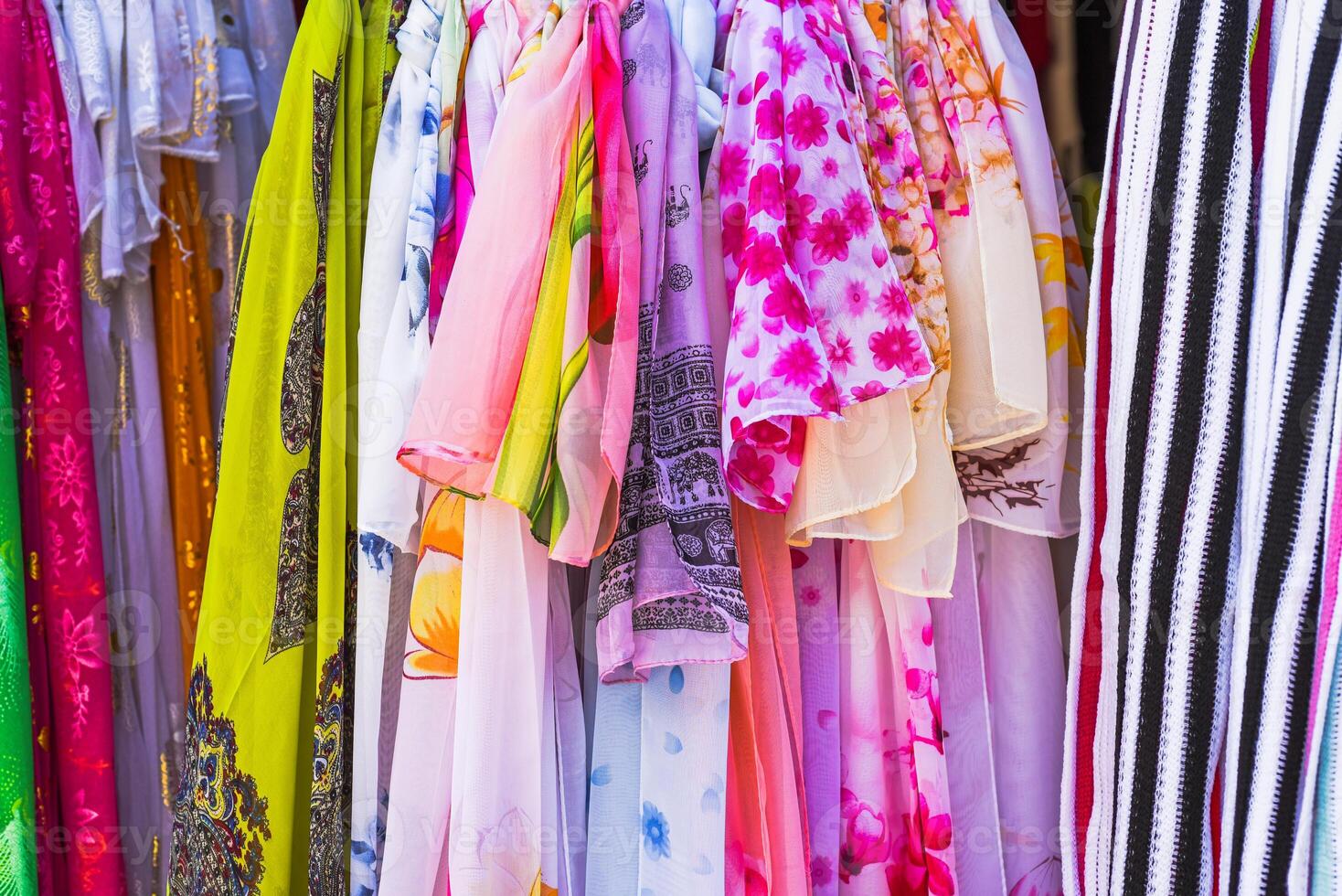 Many female spring scarves hanging in Vietnamese market photo