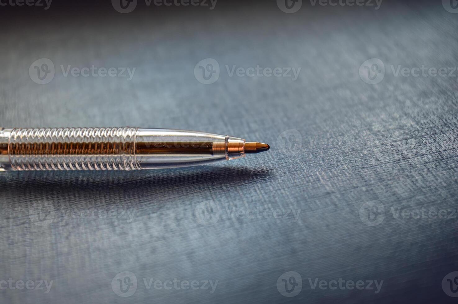 Ballpoint pen perpendicular on a gray background photo
