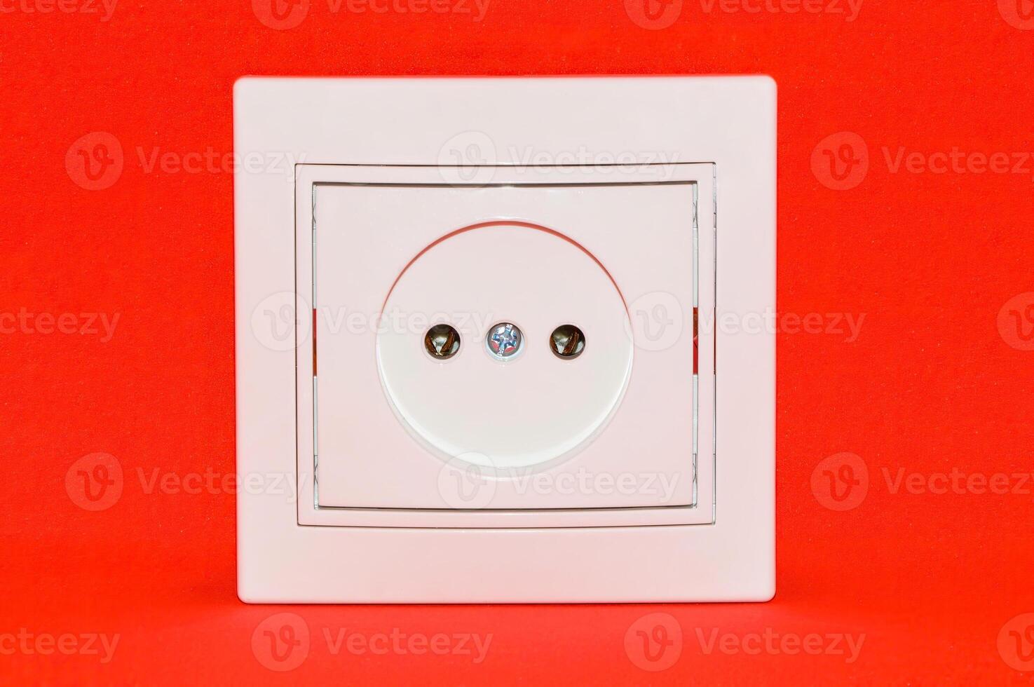 White electric socket isolated on red background photo