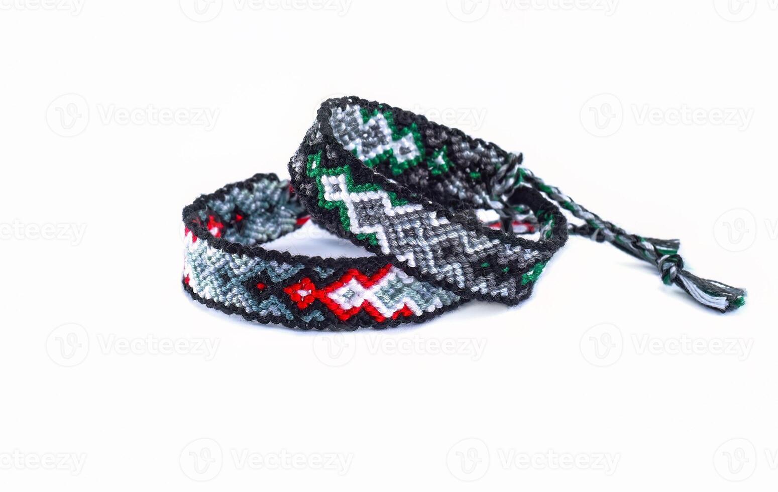 boho woven DIY friendship bracelets handmade of embroidery bright thread with knots isolated on white background photo