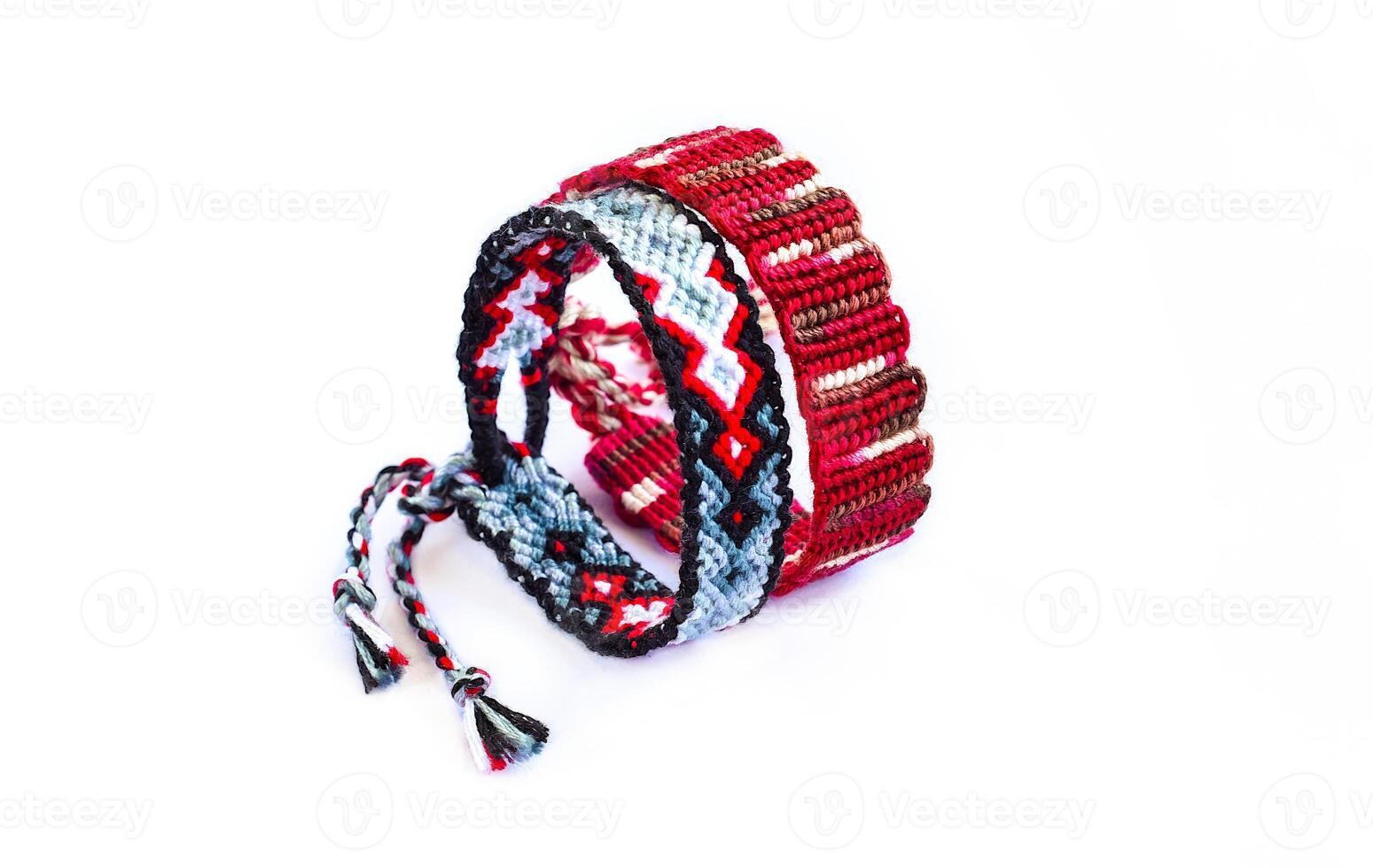 Multicolored 2 woven DIY friendship bracelets handmade of embroidery bright thread with knots isolated on white background photo