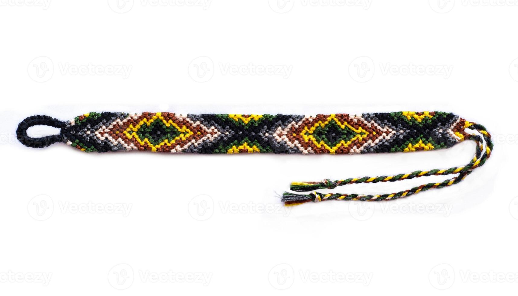 Multicolored woven DIY bracelets handmade of embroidery bright thread with knots isolated on white background photo