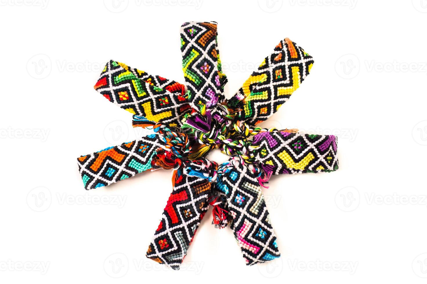 Multicolored tied woven DIY friendship bracelets handmade of embroidery bright thread with knots isolated on white background photo