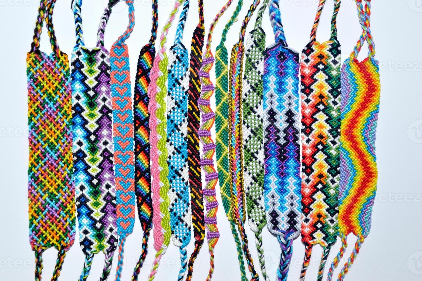 woven friendship bracelets handmade of embroidery bright thread with knots isolated on white background photo