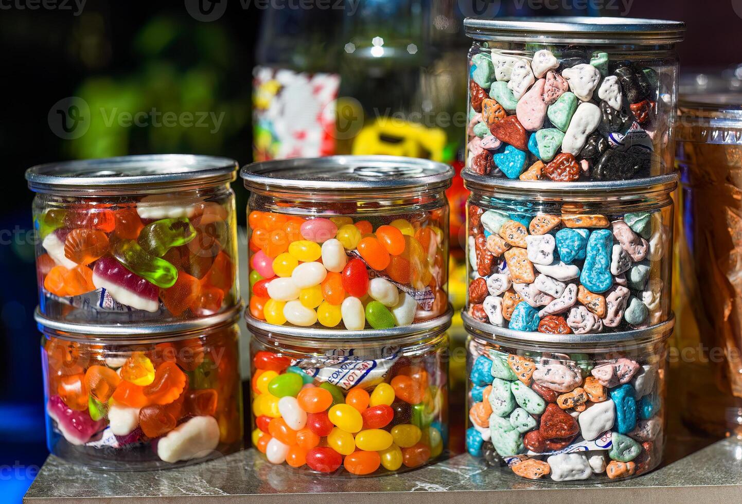 Many colorful candy and lollipops with gum in jars photo