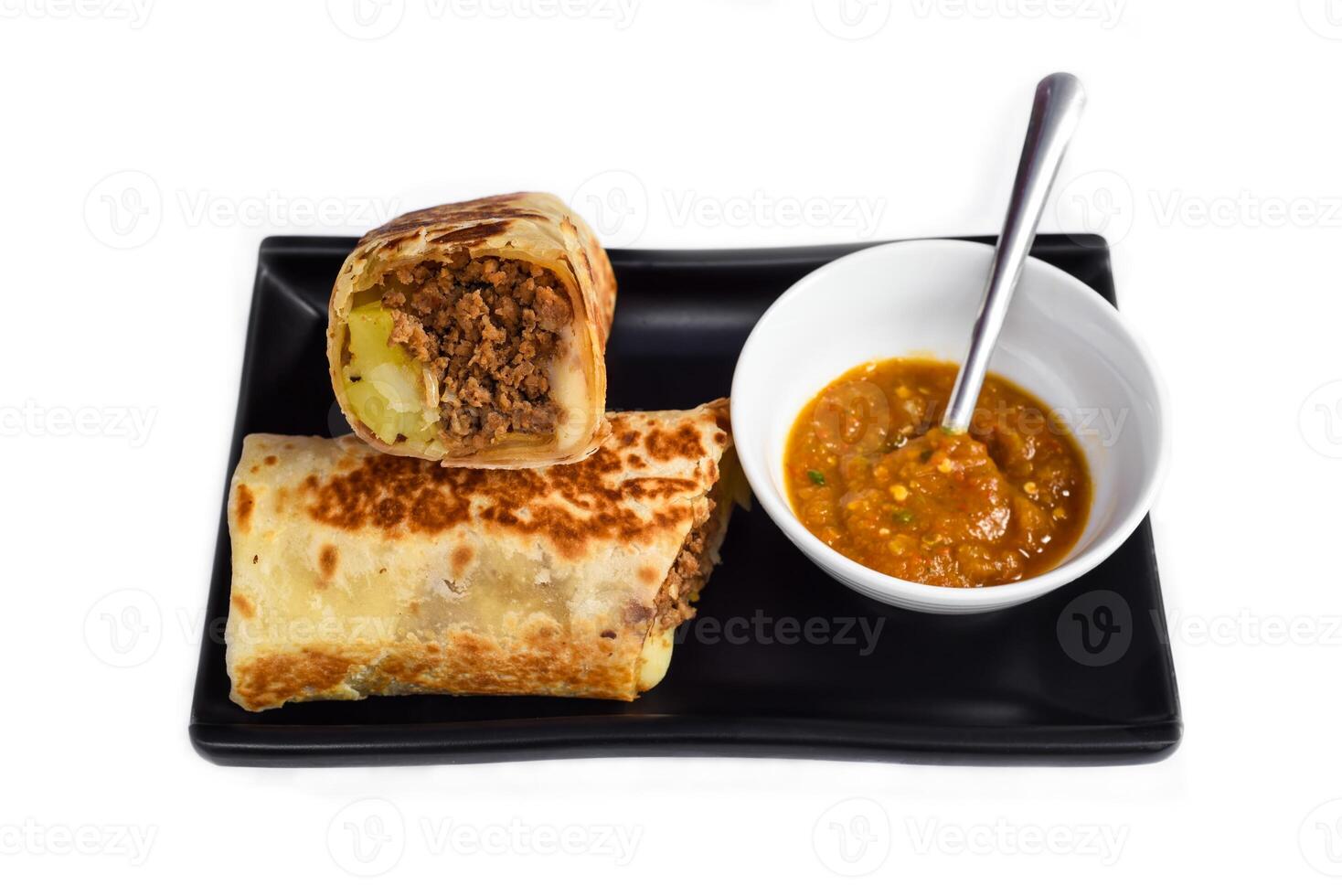 Mexican burrito with pork, cheese, potato served with sauce borracha photo