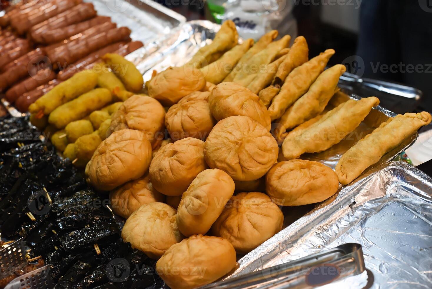 Vietnamese pies with meat and onion on a night market in food festival photo