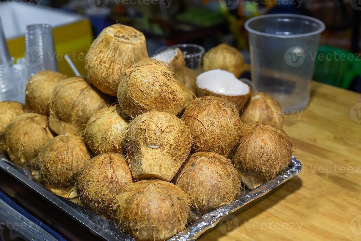 Halved and whole young coconuts for preparation of ice cream in vietnam photo