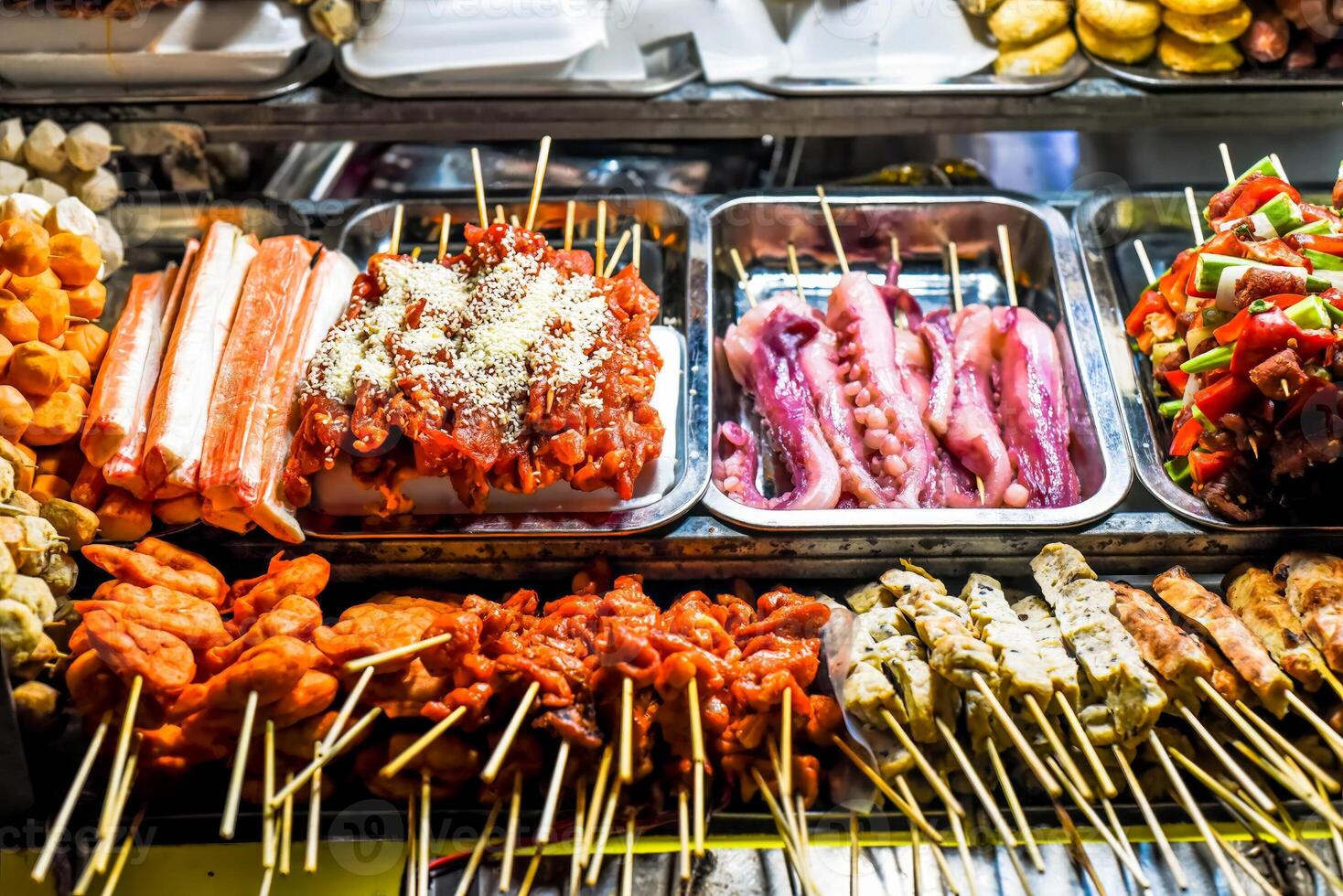 Many snacks and seafood in a vietnamese night market in Da Lat photo