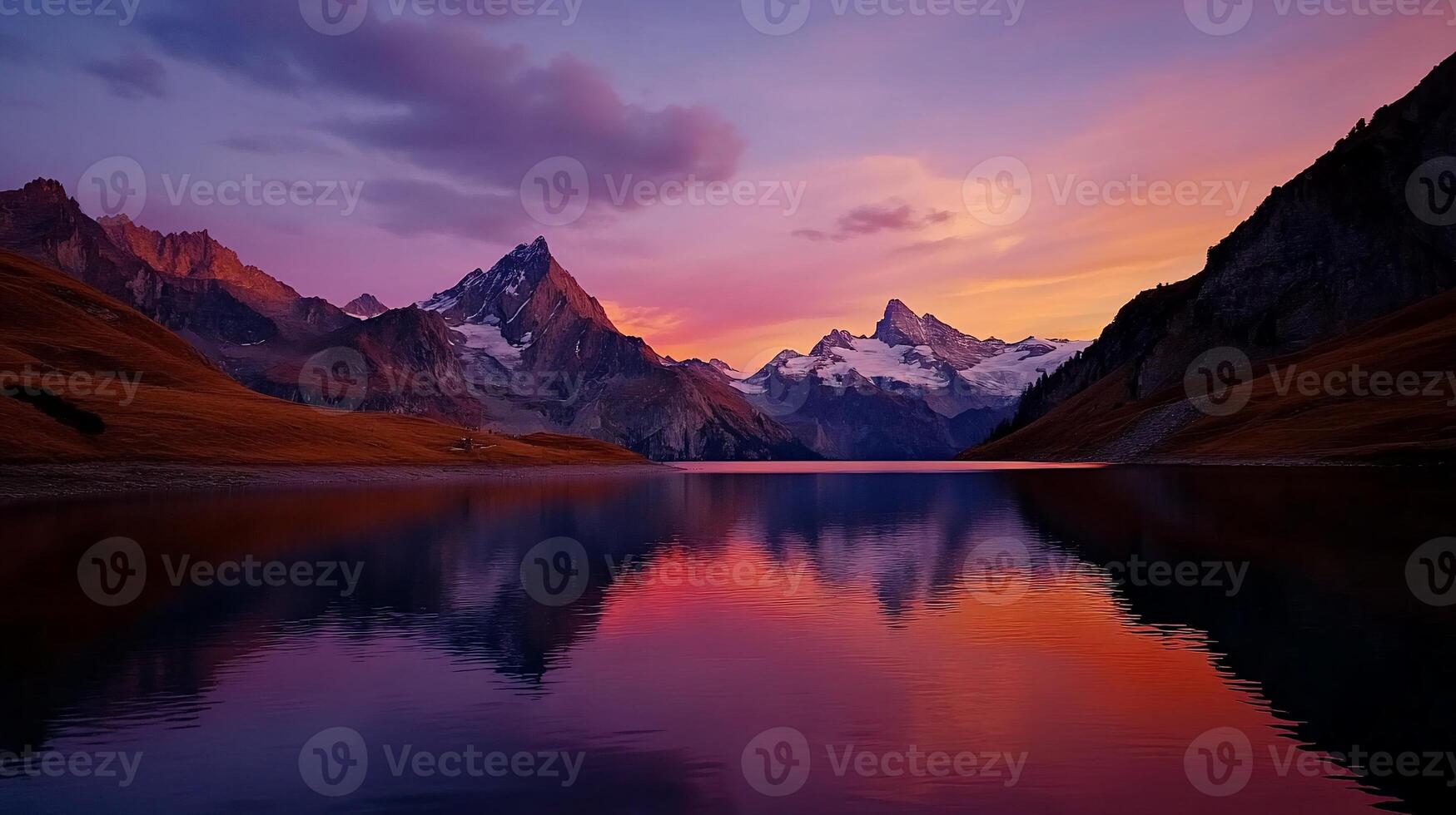 Majestic mountain range reflecting in a calm lake at sunset photo