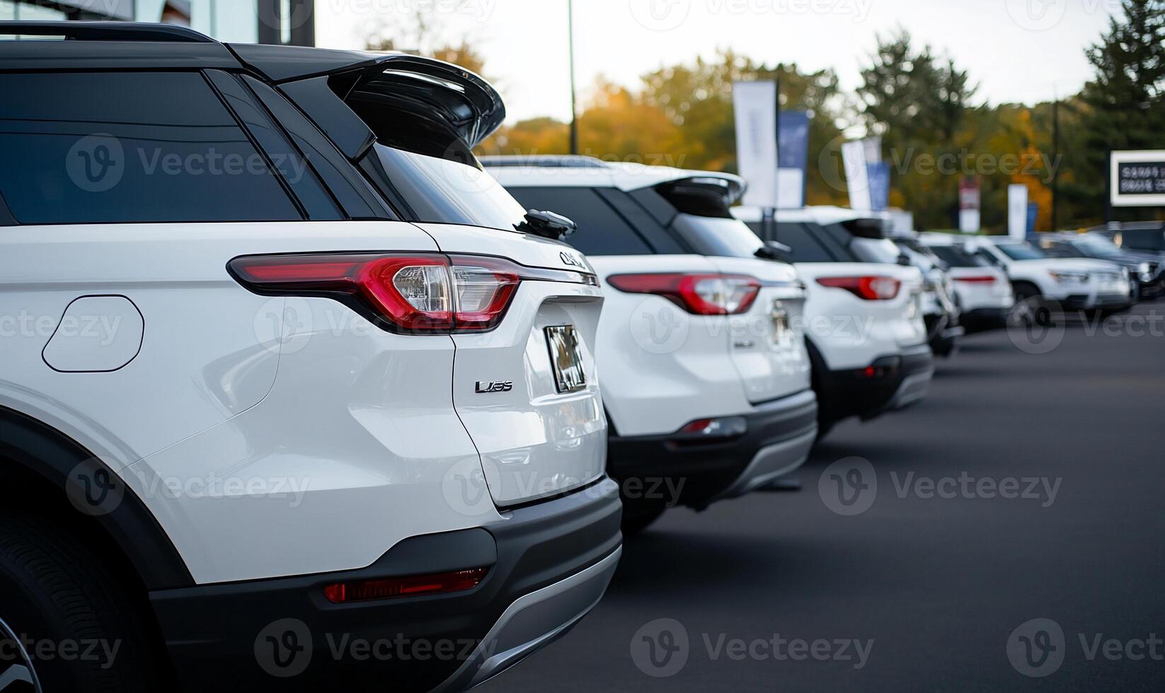 A row of white suvs parked in front of a dealership photo