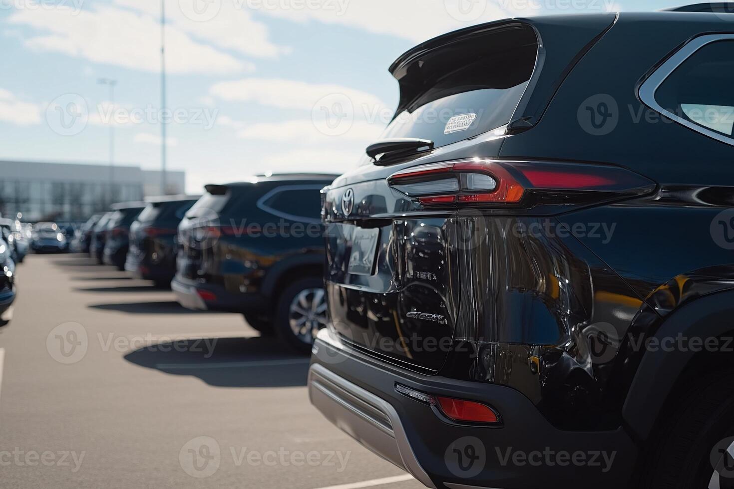 A row of black suvs parked in a parking lot photo