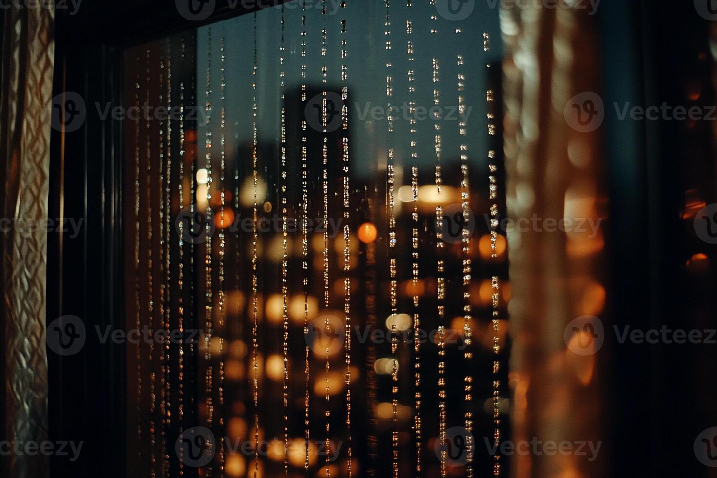 A window with lights and a city skyline in the background photo