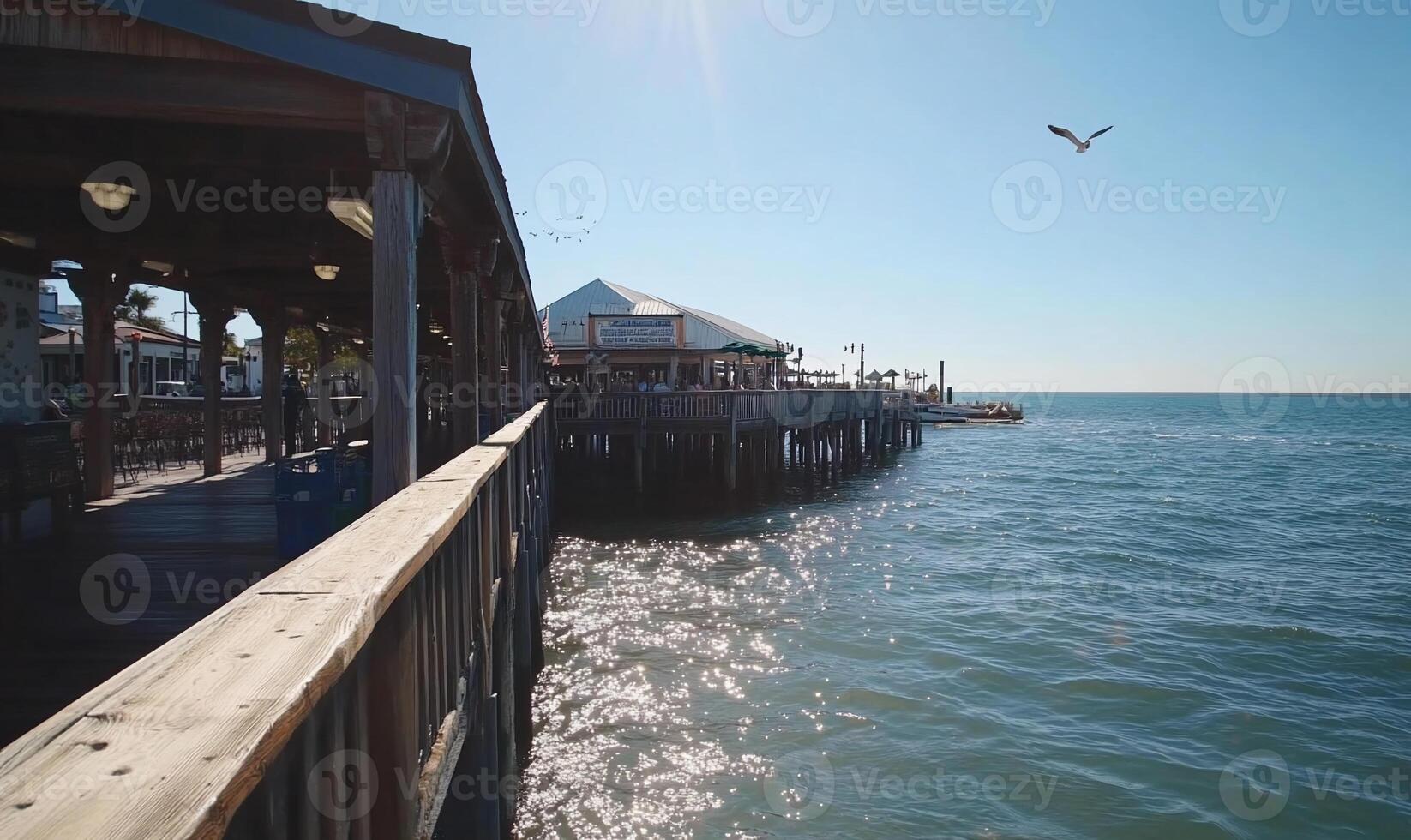 Coastal boardwalk with pier and restaurants photo