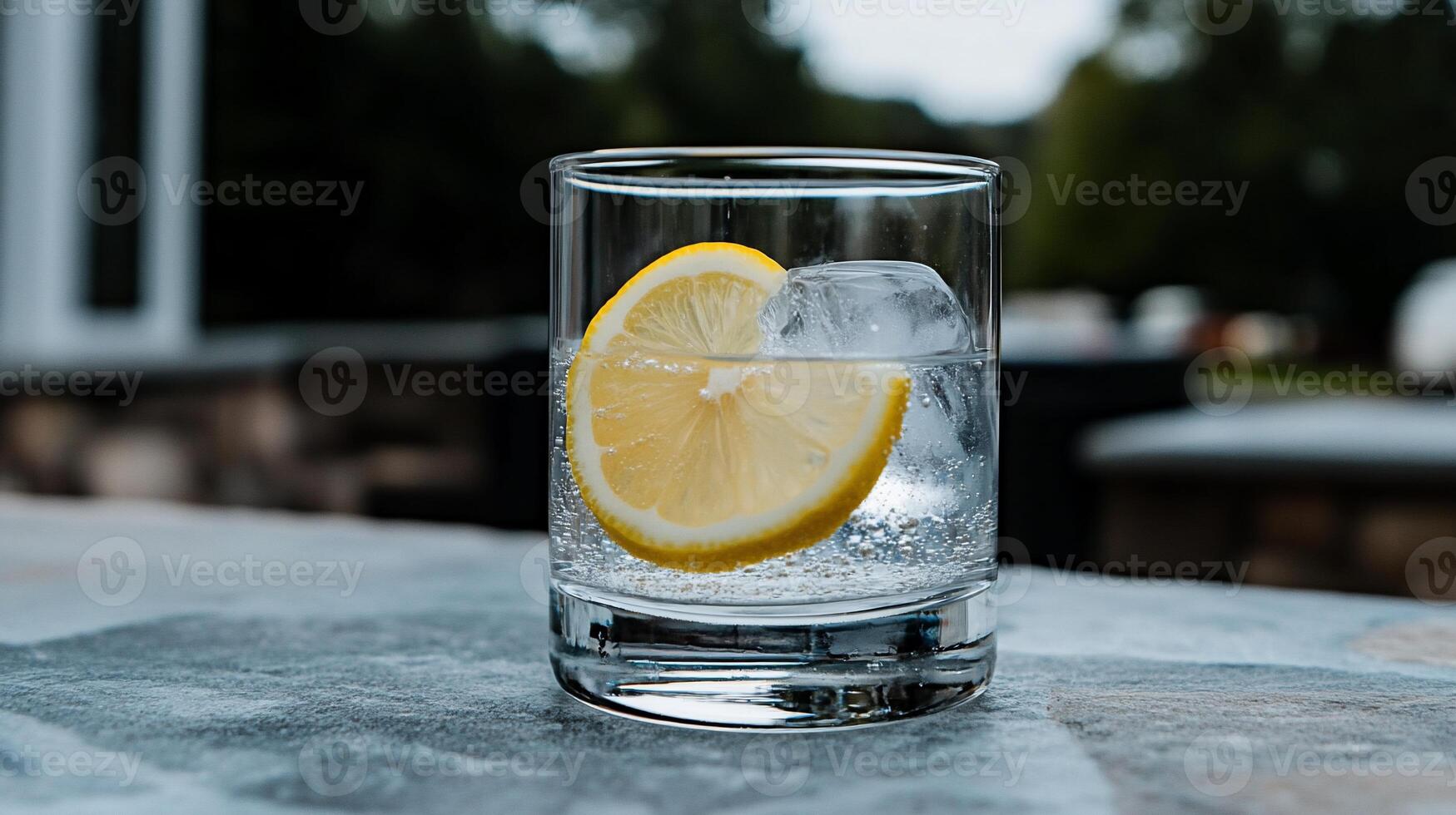 Refreshing iced water with lemon slice photo