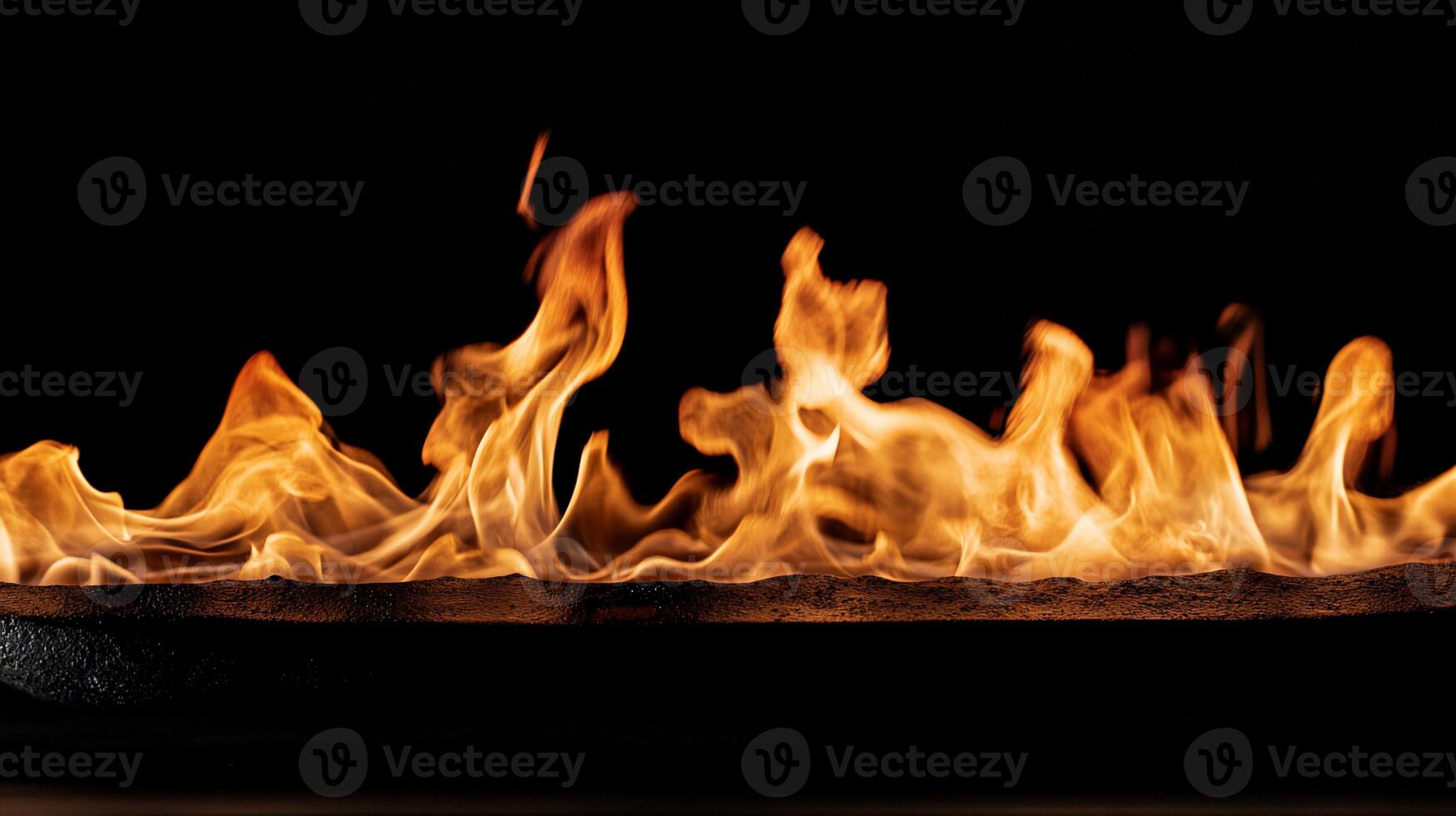 Fiery flames licking a horizontal surface photo