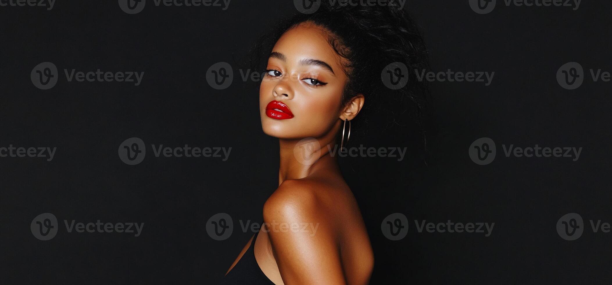 A beautiful young woman with red lipstick and black dress photo