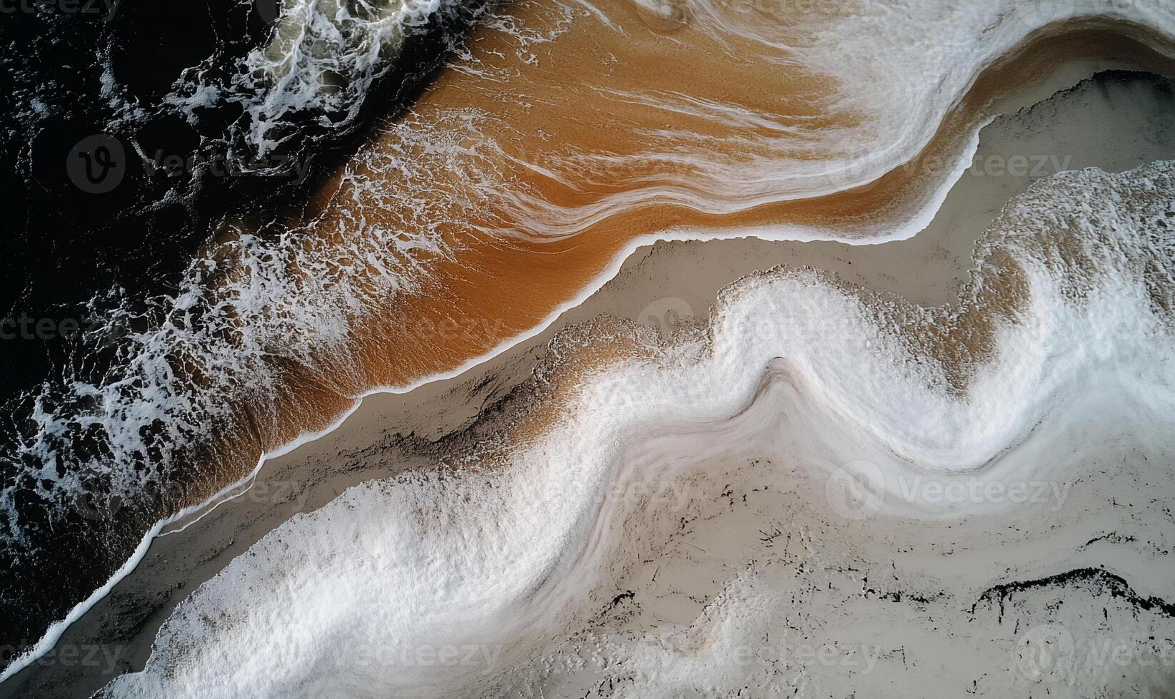 Aerial view of ocean waves meeting sandy shore, creating abstract patterns photo