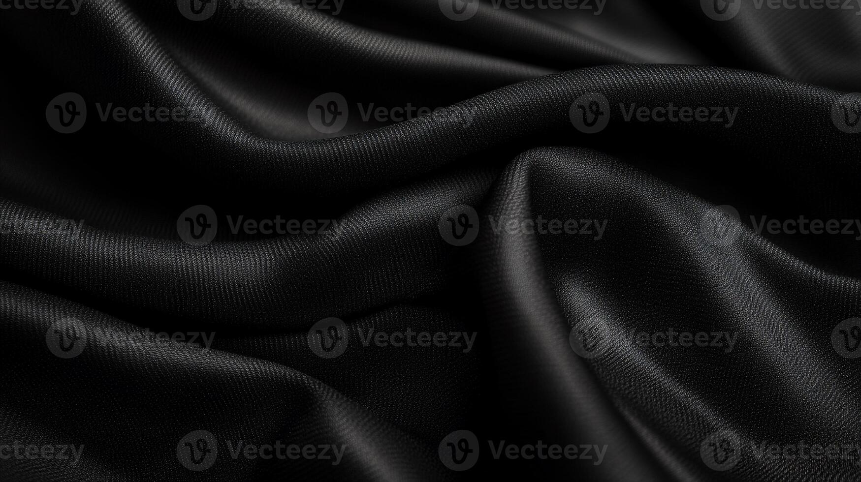 Draped black fabric with soft, flowing folds and subtle texture photo