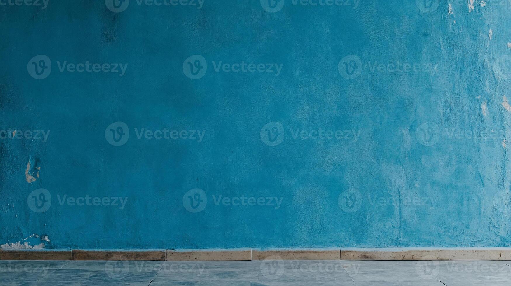 Teal textured wall with worn baseboard photo