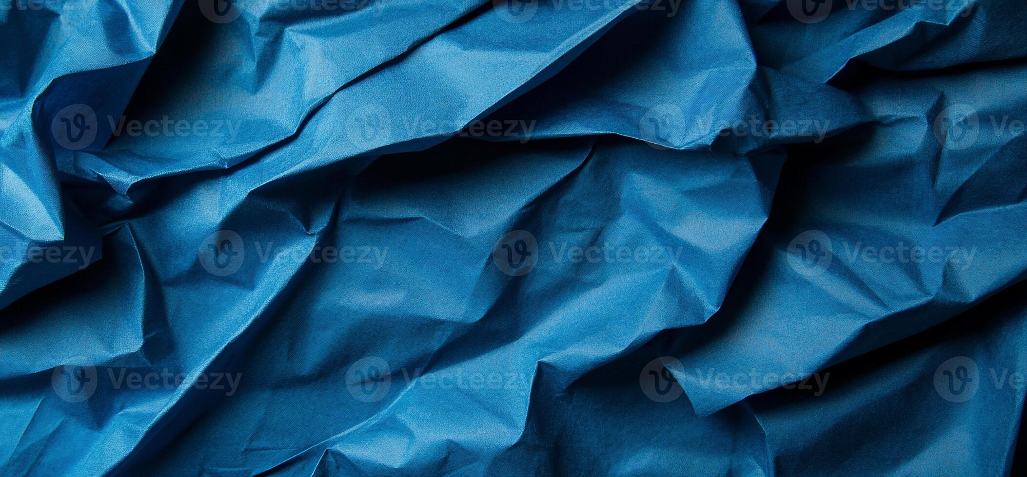 Deep blue fabric with dramatic folds and wrinkles photo