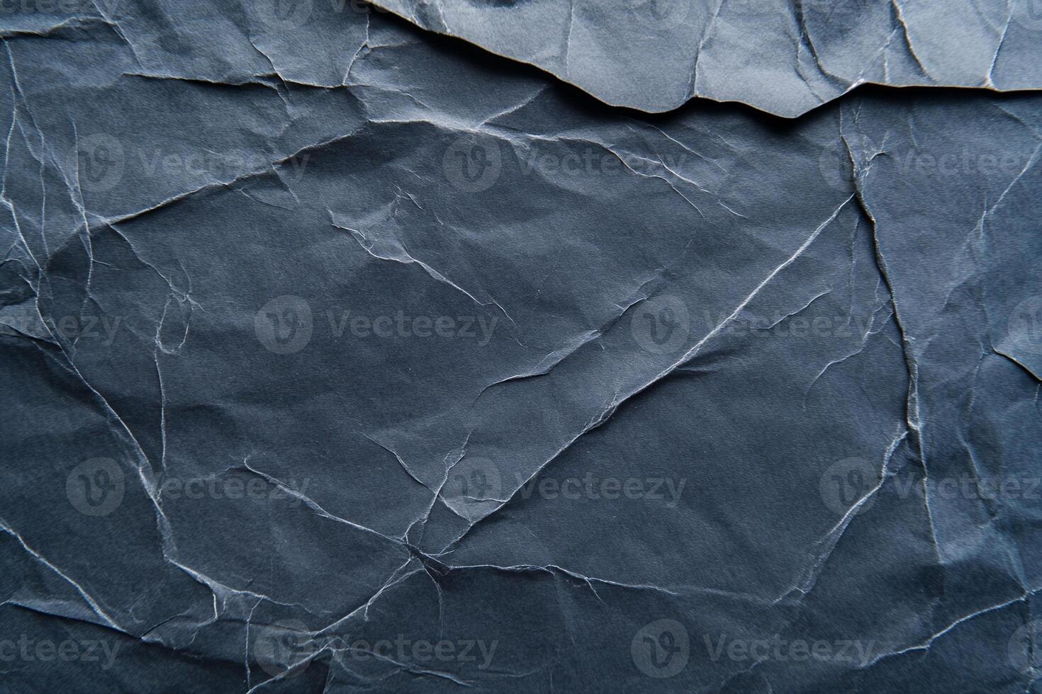 Crumpled, dark gray paper texture photo
