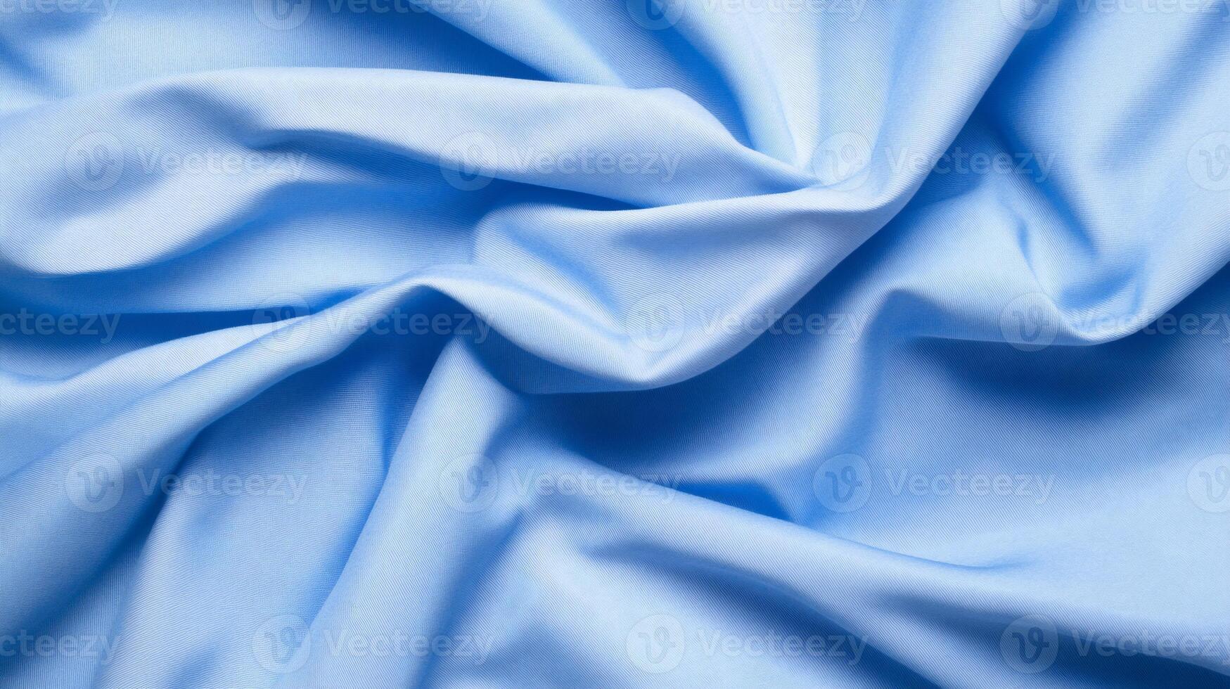 Soft, light blue fabric with gentle folds and wrinkles photo
