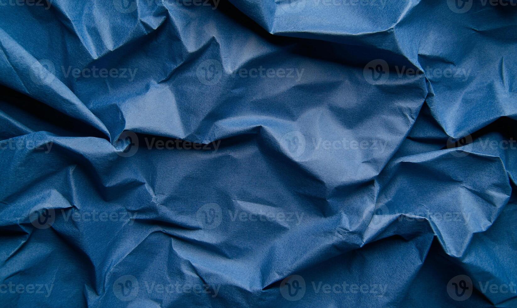 Blue crumpled paper texture background photo