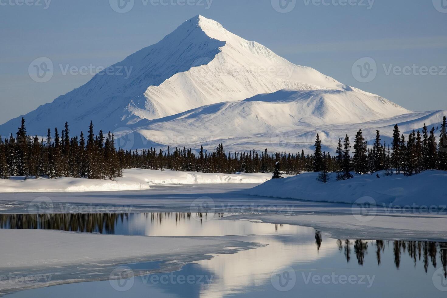 Snow-capped peak reflected in a frozen river photo