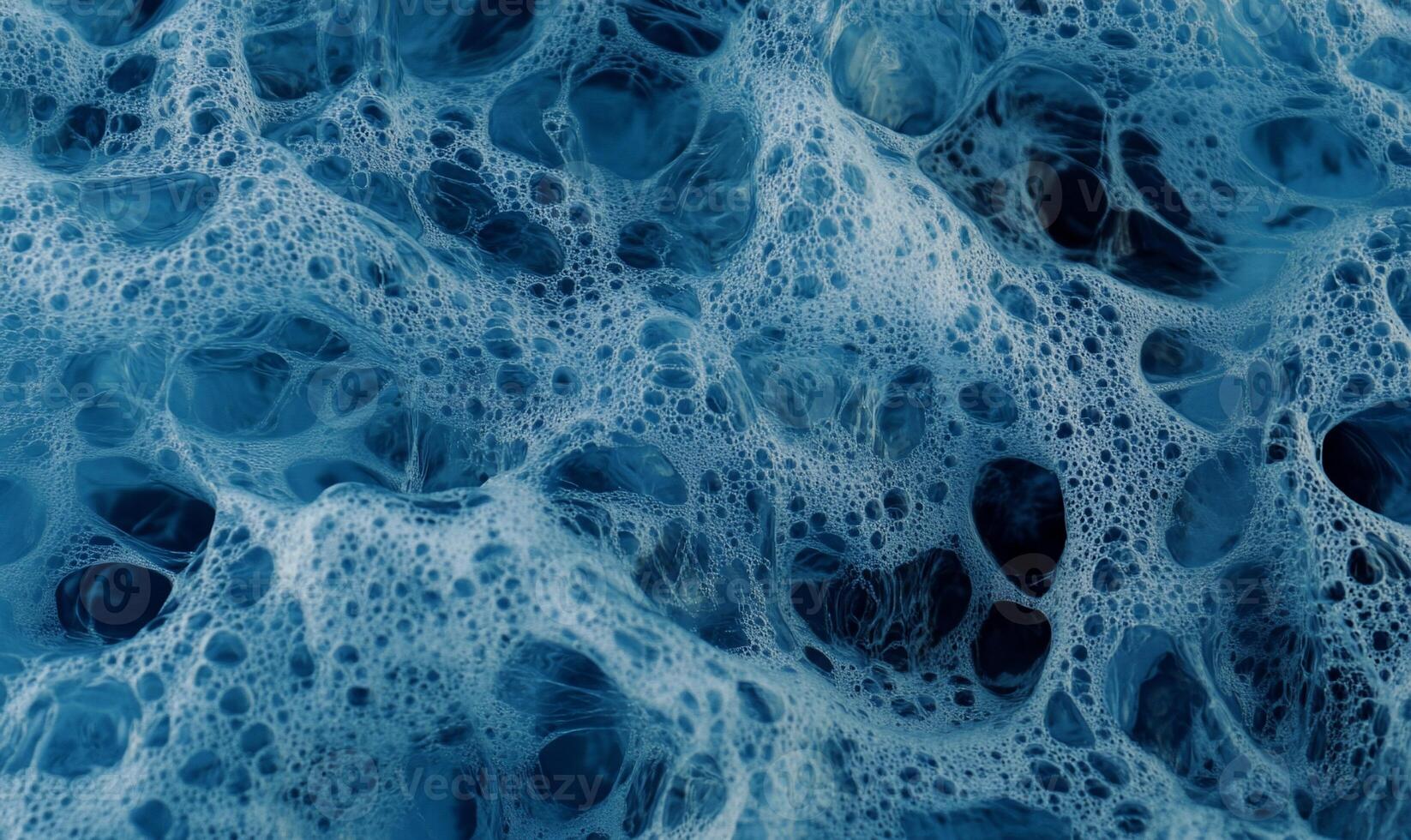 Abstract blue foam texture with intricate, organic shapes and air bubbles photo