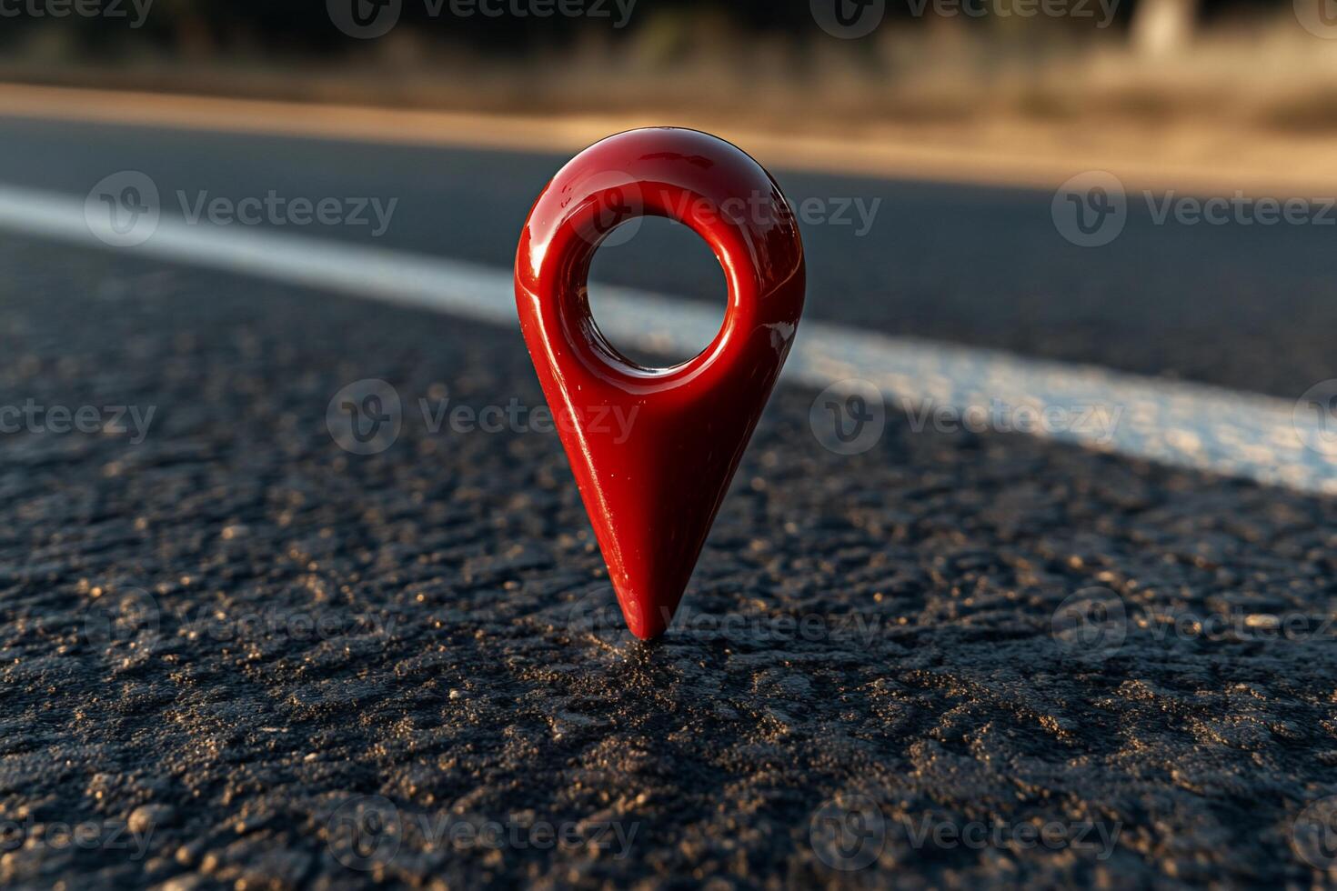 Red location marker on asphalt road photo