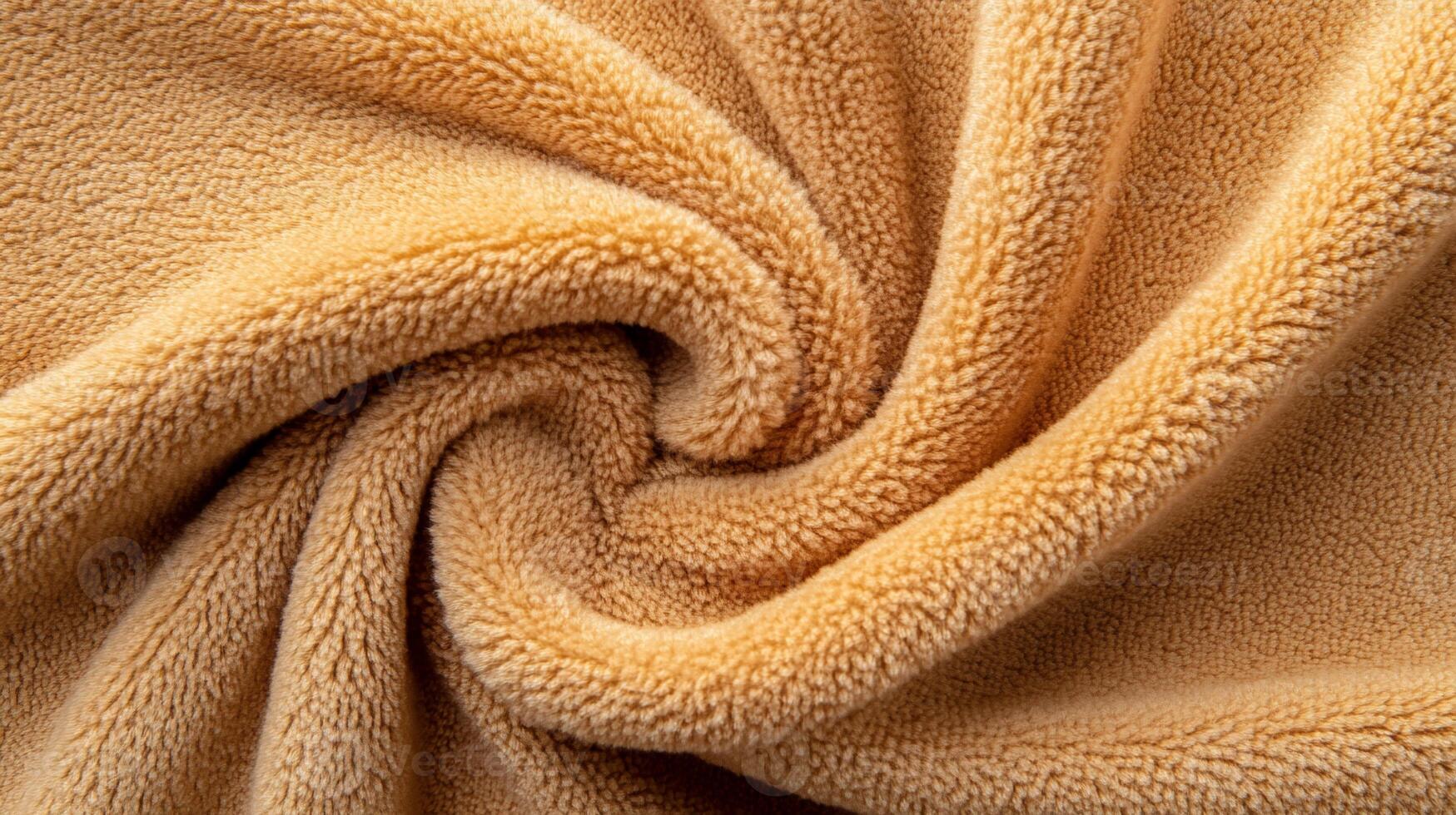 Soft, tan, plush fabric swirled elegantly photo
