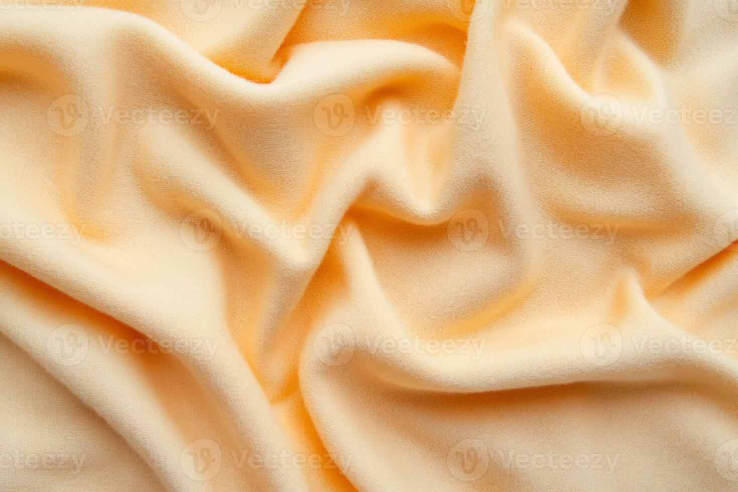 Soft, pale orange fabric with gentle folds photo